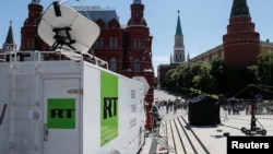 FILE - Vehicles of Russian state-controlled broadcaster RT are seen near the Red Square in Moscow, Russia, June 15, 2018.