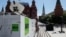 FILE - Vehicles of Russian state-controlled broadcaster RT are seen near the Red Square in Moscow, Russia, June 15, 2018.
