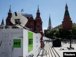 FILE - Vehicles of Russian state-controlled broadcaster RT are seen near the Red Square in Moscow, Russia, June 15, 2018.