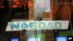 Electronic billboards reflected in the windows of NASDAQ in New York, Aug. 22, 2013. 