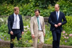 Britain's Prince William, right, and Prince Harry speak with garden designer Pip Morrison during the unveiling of a statue they commissioned of their mother Diana, Princess of Wales, July 1, 2021.