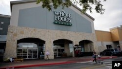 A shopper leaves a Whole Foods Market, June 16, 2017, in San Antonio, Texas.