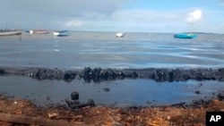 This photo taken and provided by Sophie Seneque, shows oil polluting the foreshore of the public beach in Riviere des Creoles, Mauritius, Saturday Aug. 8, 2020, after it leaked from the MV Wakashio, a bulk carrier ship that recently ran aground off the so
