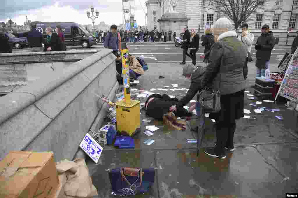 A woman lies injured after a shooting incident on Westminster Bridge in London, March 22, 2017. 