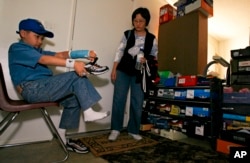 Moshe Kai Cavalin, 10, gets ready for school at home with his mother Shu-Chen Chien in Downey, Calif.