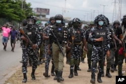 Police officers patrol during a protestation  against the economical  hardship connected  the thoroughfare  successful  Lagos, Nigeria, Aug 2, 2024.