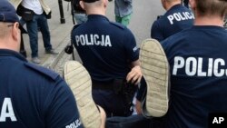 Police officers carry away a protester from the parliament area after lawmakers voted to approve a law on court control, in the parliament in Warsaw, Poland, July 20, 2017.