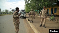 Members of Amhara Special Forces stand guard along a street in Humera town, Ethiopia, July 1, 2021. 