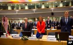 European Union High Representative Federica Mogherini, center right, and United Nations Secretary General Antonio Guterres, center left, stand for a moment of silence for the Syrian victims of war at an EU Syria conference at the Europa building in Brusse