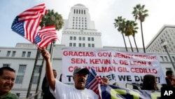 Ipolito Nurez celebrates outside City Hall after California Gov. Jerry Brown signed the bill AB 60, which allows immigrants in the country illegally to obtain driver licenses, Oct. 3, 2013.