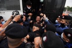 FILE - Police detain pro-democracy protester Jatupat "Pai Dao Din" Boonpattararaksa during a mass rally to call for the ouster of Prime Minister Prayuth Chan-ocha's government and reforms in the monarchy, in Bangkok, Thailand, Oct. 13, 2020.