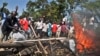 Demonstrators burn tires to protest the results of the Orange Democratic Movement (ODM) primary elections, in Aherou, Kenya on Sunday, Jan. 20, 2013. This week, political parties held internal elections to decide candidates who will vie for gubernatorial,