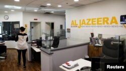 FILE: An employee walks inside an office of Qatar-based Al Jazeera network in Jerusalem, June 13, 2017. 