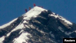 A team of climbers, including 80-year-old Japanese mountaineer Yuichiro Miura, stand on the summit of Mount Everest, in this photo taken by Kyodo, May 23, 2013.