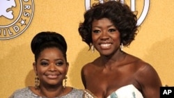 Octavia Spencer, winner of award for outstanding performance by a female actor in a supporting role for "The Help," left, and Viola Davis, winner of the award for outstanding performance by a female actor in a leading role for "The Help," pose backstage a