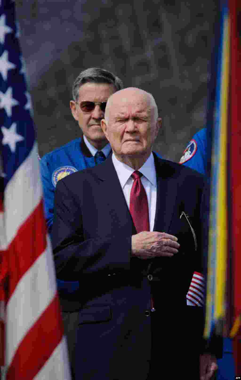 Former astronaut and US Senator John Glenn holds his hand to his heart during the playing of the National Anthem at the transfer ceremony for space shuttle Discovery. (NASA/Paul E. Alers)