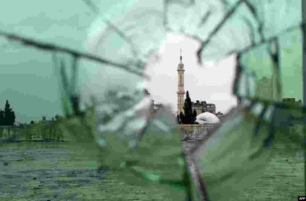 A mosque is pictured through shattered glass in the old city of Homs, Syria as rebel fighters withdrew from the city center in line with a negotiated withdrawal deal with the government after having held out under tight siege for nearly two years.