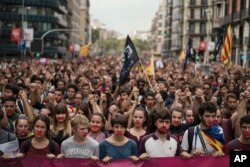 Independence supporters march during a demonstration downtown Barcelona, Spain, Oct. 2, 2017.
