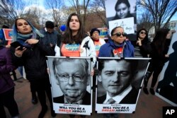 FILE - Amanda Bayer, left holding banner, and Marisol Maqueda, right with banner, from Mexico whose daughter Maria Torres also from Mexico City is a DACA recipient finishing her masters degree in Arizona, join a rally outside the White House in Washington