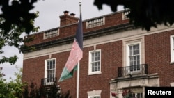 FILE - An Afghan flag flutters outside the Afghan embassy in Washington, Aug. 15, 2021, on the day Taliban insurgents entered Afghanistan's capital, Kabul. 