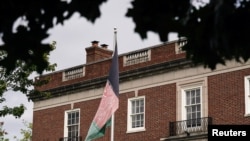FILE - An Afghan flag flutters outside the Afghan embassy in Washington, Aug. 15, 2021. 