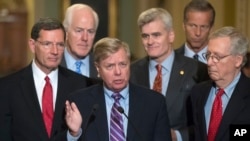 Sen. Lindsey Graham, R-S.C., joined by, from left, Sen. John Barrasso, R-Wyo., Majority Whip John Cornyn, R-Texas, Sen. Bill Cassidy, R-La., Sen. John Thune, R-S.D., and Senate Majority Leader Mitch McConnell, R-Ky., speaks to reporters at the Capitol in Washington, Sept. 19, 2017. 