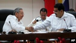 Cuba's President Raul Castro, left, shakes hands with Venezuela's President Nicolas Maduro at the ALBA summit about Ebola in Havana, Cuba, Monday, Oct. 20, 2014.