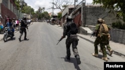 Haitian and Kenyan police patrol a neighborhood in Port-au-Prince, Haiti, on June 28, 2024.