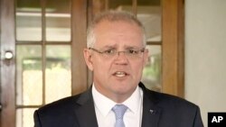 In this image made from video, Australia's Prime Minister Scott Morrison talks to media on May 17, 2019, in Cairns, Australia. 