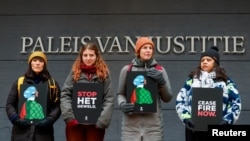 FILE - Demonstrators protest outside a district court on the day of a hearing of a case against against the export of F35 fighter jet parts to Israel in The Hague, Netherlands, December 4, 2023.