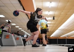 Maria Bulanova, a member of the Professional Women's Bowling Association and an assistant coach at St. Francis College, practices at Kingpin's Alley and Family Center, Wednesday, June 15, 2022, in Glens Falls, N.Y. Title IX has opened the door for thousands of female athletes from abroad to get an American education and a shot at a life and career in the United States. (AP Photo/Hans Pennink)