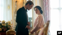 In this image released by Netflix, Claire Foy as Queen Elizabeth II, right, and Matt Smith as Prince Philip in a scene from "The Crown." (Robert Viglasky/Netflix via AP)