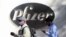 People walk by the Pfizer world headquarters in New York on Nov. 9, 2020.