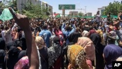 Protesters rally in front of the military headquarters in the capital Khartoum, Sudan, Monday, April 8, 2019.