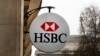 FILE - The logo of HSBC Bank is displayed on the facade of HSBC France headquarters on the Champs Elysees in Paris, Feb. 9, 2015.