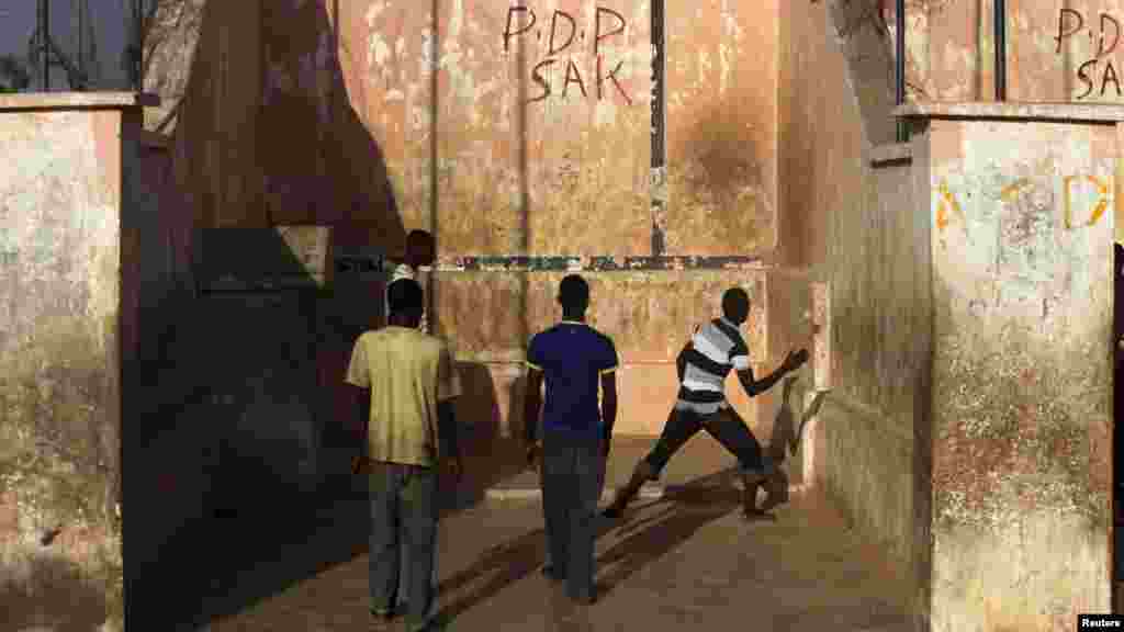 Youths play a game of Eton fives in a court in Katsina.