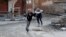 Children run across a street to avoid snipers in Deir al-Zor, eastern Syria Feb. 16, 2014. 