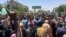 Protesters rally in front of the military headquarters in the capital Khartoum, Sudan, Monday, April 8, 2019.
