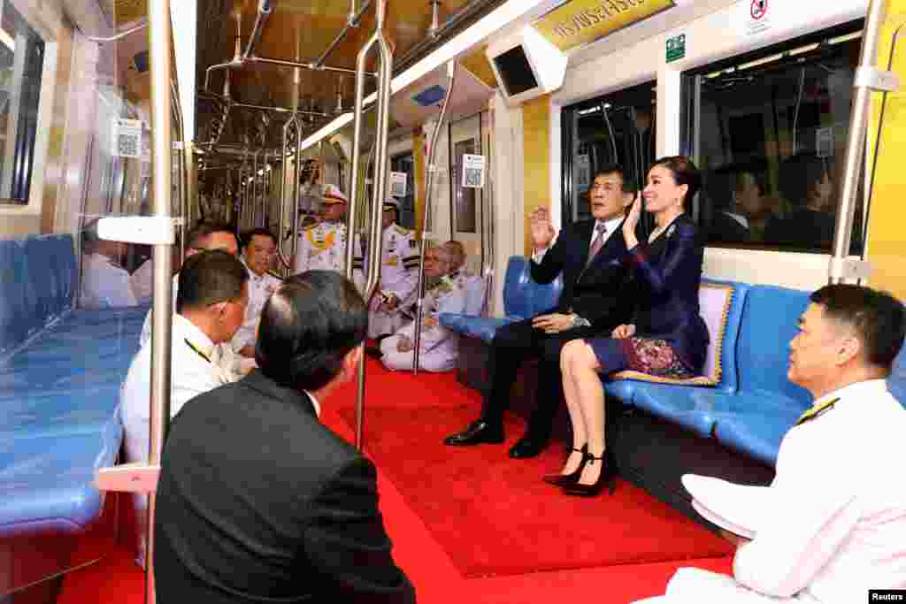 Thailand&#39;s King Maha Vajiralongkorn and Queen Suthida ride on an MRT during an inauguration of a new subway station in Bangkok.