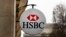 FILE - The logo of HSBC Bank is displayed on the facade of HSBC France headquarters on the Champs Elysees in Paris, Feb. 9, 2015.