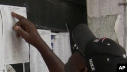 A voter looks at a polling station list in Port-au-Prince, Haiti