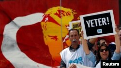 FILE - Members of the Journalists Union of Turkey (TGS) carry placards reading 'Enough!' during a demonstration to mark World Press Freedom Day in central Istanbul, Turkey, May 3, 2017. (REUTERS/Murad Sezer)