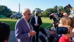 President Joe Biden speaks with members of the press before boarding Marine One on the South Lawn of the White House, in Washington, Oct. 2, 2021.