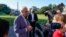 President Joe Biden speaks with members of the press before boarding Marine One on the South Lawn of the White House, in Washington, Oct. 2, 2021.