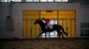 FILE - A Chinese jockey rides a horse at an equestrian and horse industry show in Beijing.