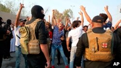 Protesters chant anti-government slogans while security forces prevent them from storming the governor's building during protests demanding better public services and jobs in Basra, 340 miles (550 km) southeast of Baghdad, Iraq, Sept. 5, 2018. 