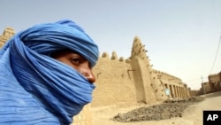 A Tuareg nomad stands near the 13th century mosque at Timbuktu, Mali (file photo).
