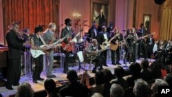 President Barack Obama and first lady Michelle Obama listen to performance during the White House Music Series saluting Blues Music in recognition of Black History Month, in the East Room of the White House in Washington, February 21, 2012.