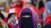 A Muslim veiled supporter of India's opposition Congress party looks on during an election rally on the outskirts of Srinagar, Indian controlled Kashmir, Sept. 23, 2024.