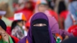 A Muslim veiled supporter of India's opposition Congress party looks on during an election rally on the outskirts of Srinagar, Indian controlled Kashmir, Sept. 23, 2024.